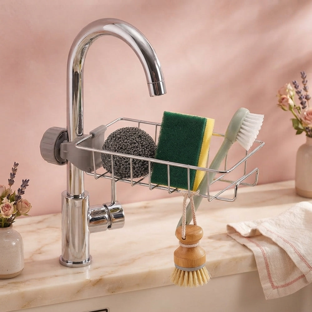A minimalist sink caddy organizer on a clean marble countertop, surrounded by curated kitchen supplies and soft blush-toned d
